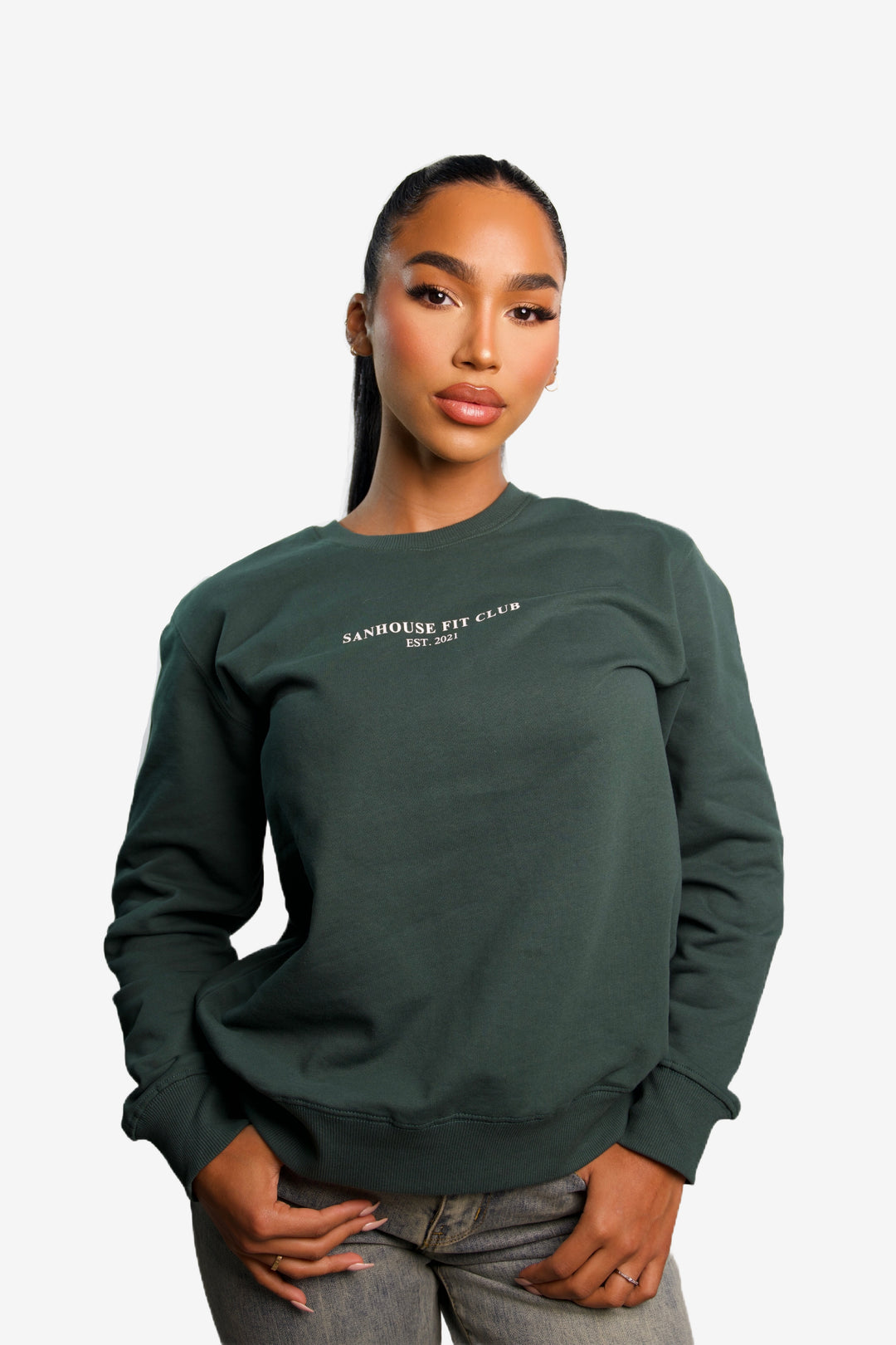 Front view of model wearing a green sweatshirt for women, casual loungewear style.