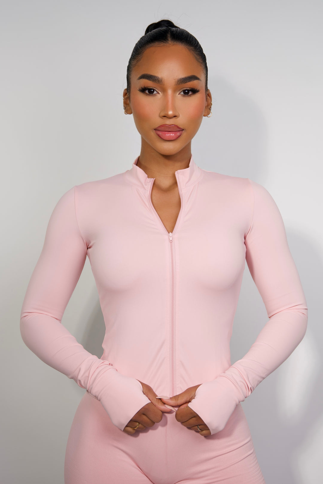Model wearing the Sanhouse Fit pink zip up jacket for sculpting fit