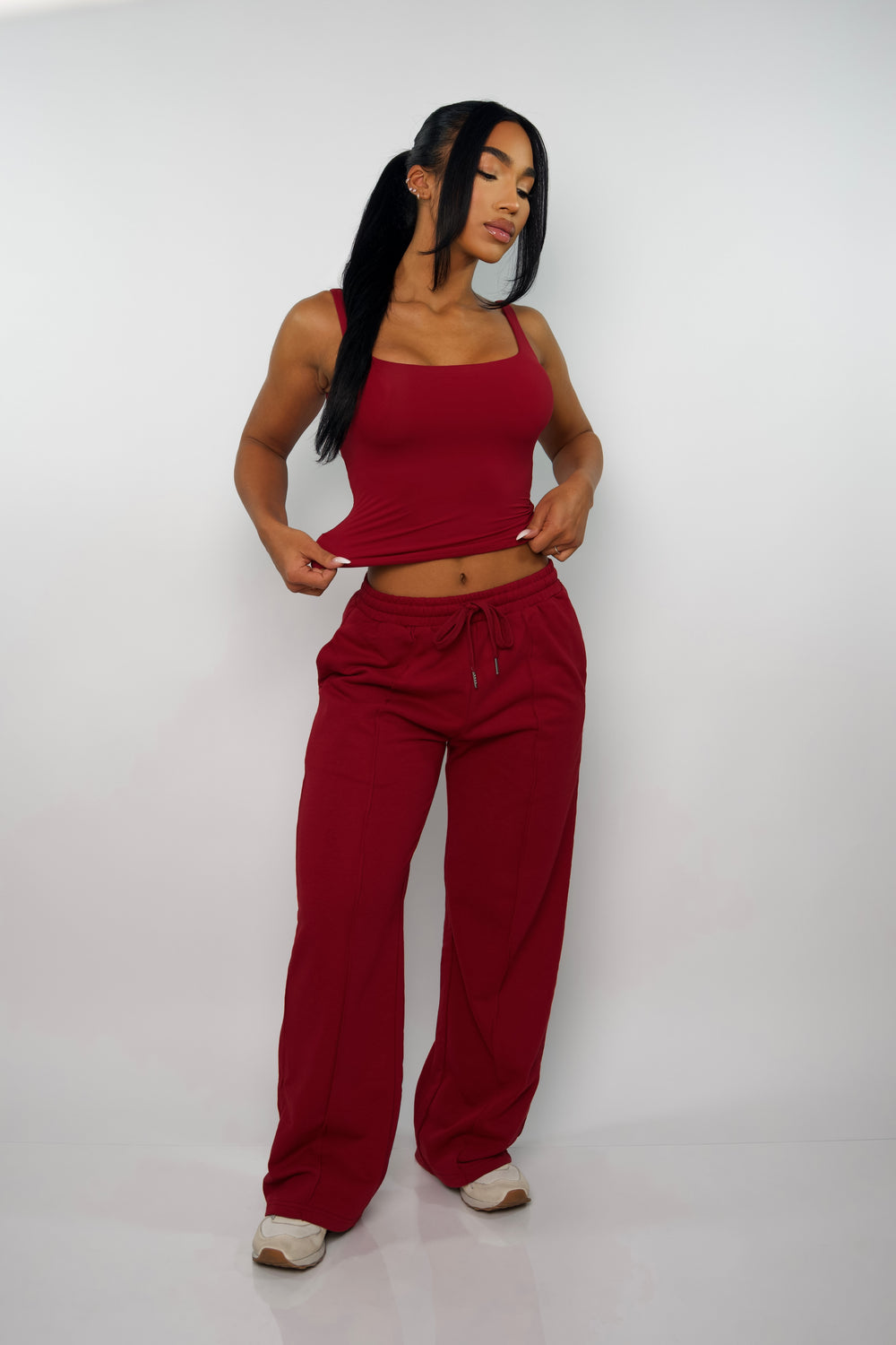 Full body front view of model wearing a red activewear tank top, perfect for gym, workouts, or layering.