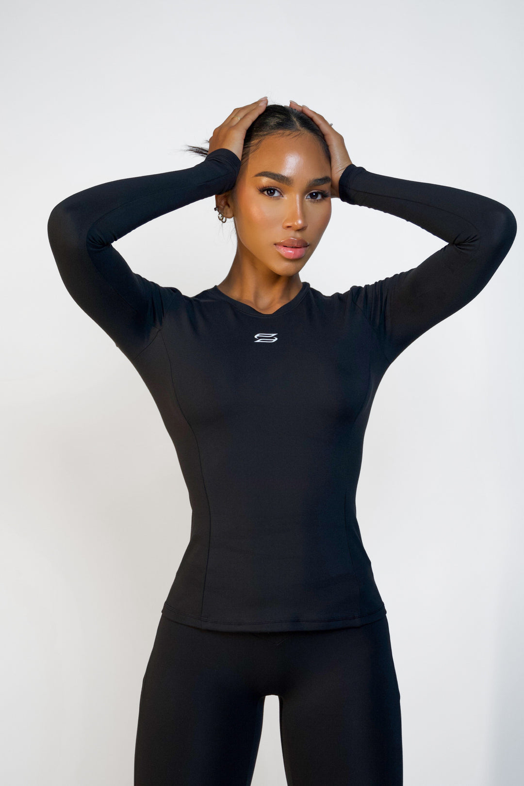 Black long sleeve workout top for women with ideal for training or athleisure wear