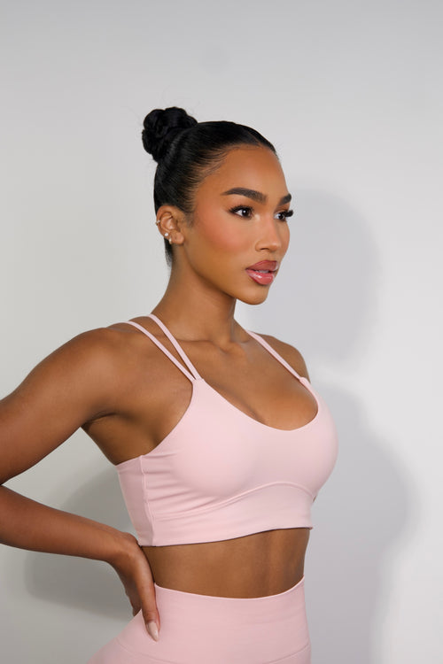 Side view of pink sports bra for women with breathable, moisture-wicking fabric and stylish design from Sanhouse Fit.